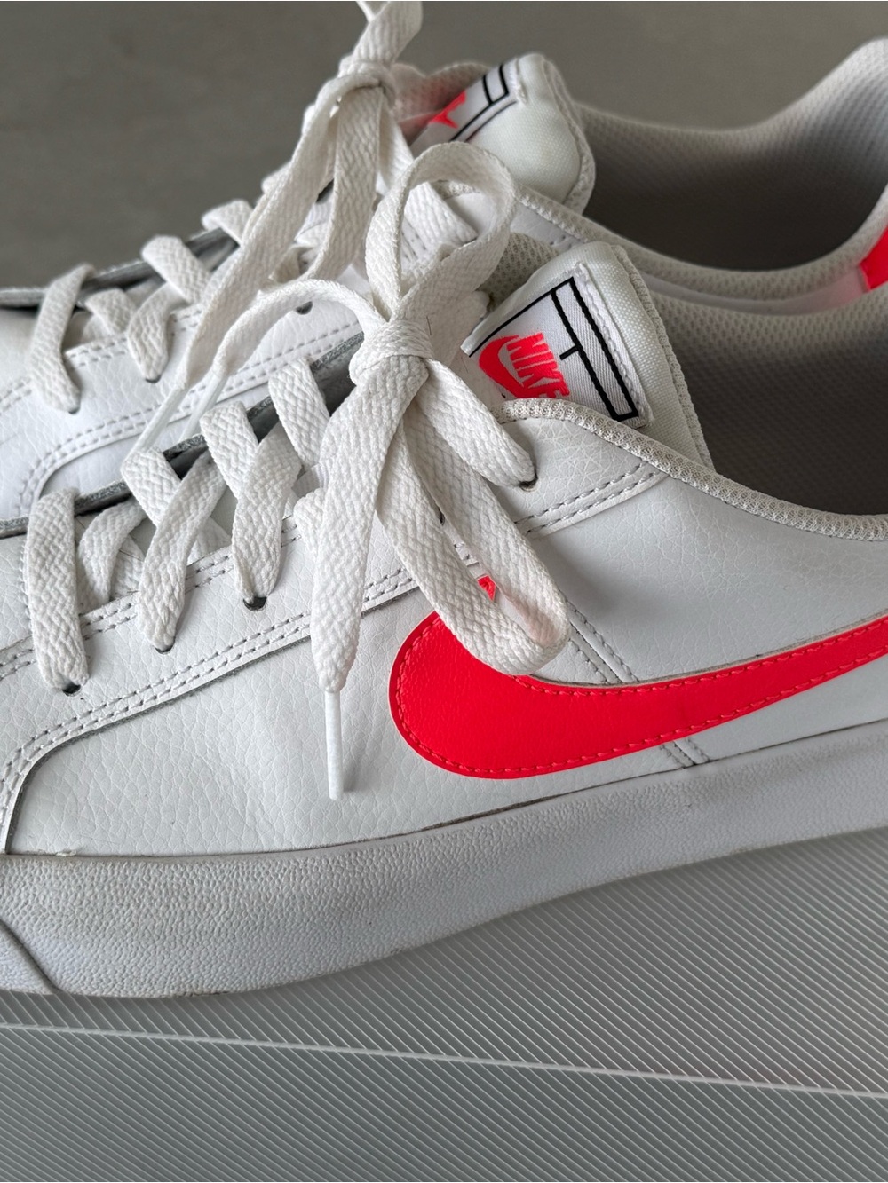 Nike White Low-Top Sneakers with Neon Pink Swoosh